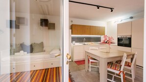 Una cucina moderna con mobili in legno, un tavolo da pranzo e un forno integrato.