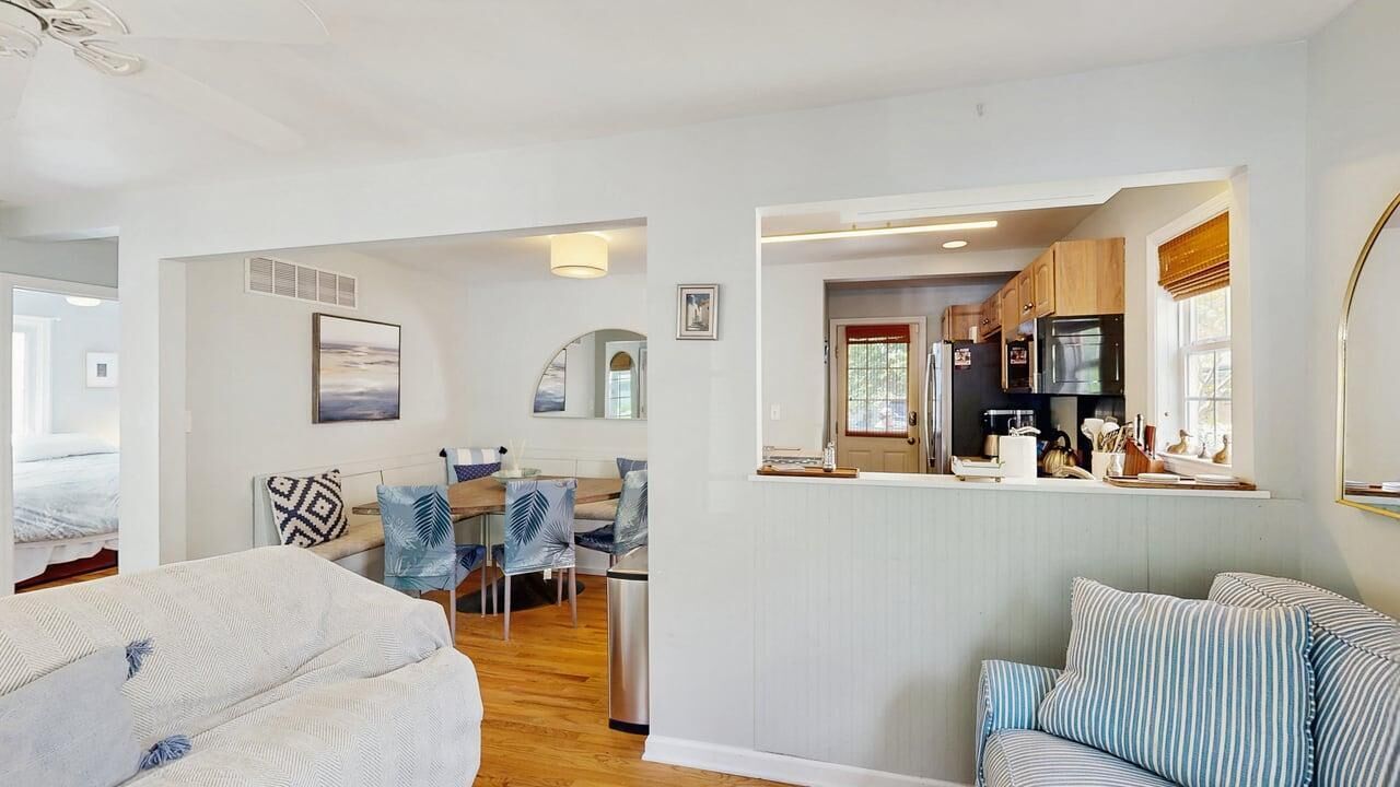 A modern interior with a dining area, kitchen, and seating space.