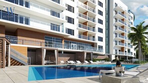 Un hôtel moderne doté d’une piscine, d’un espace extérieur aménagé et d’un bâtiment à plusieurs étages.