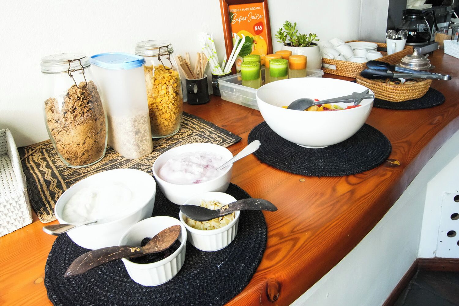 A breakfast buffet with various food items and utensils.