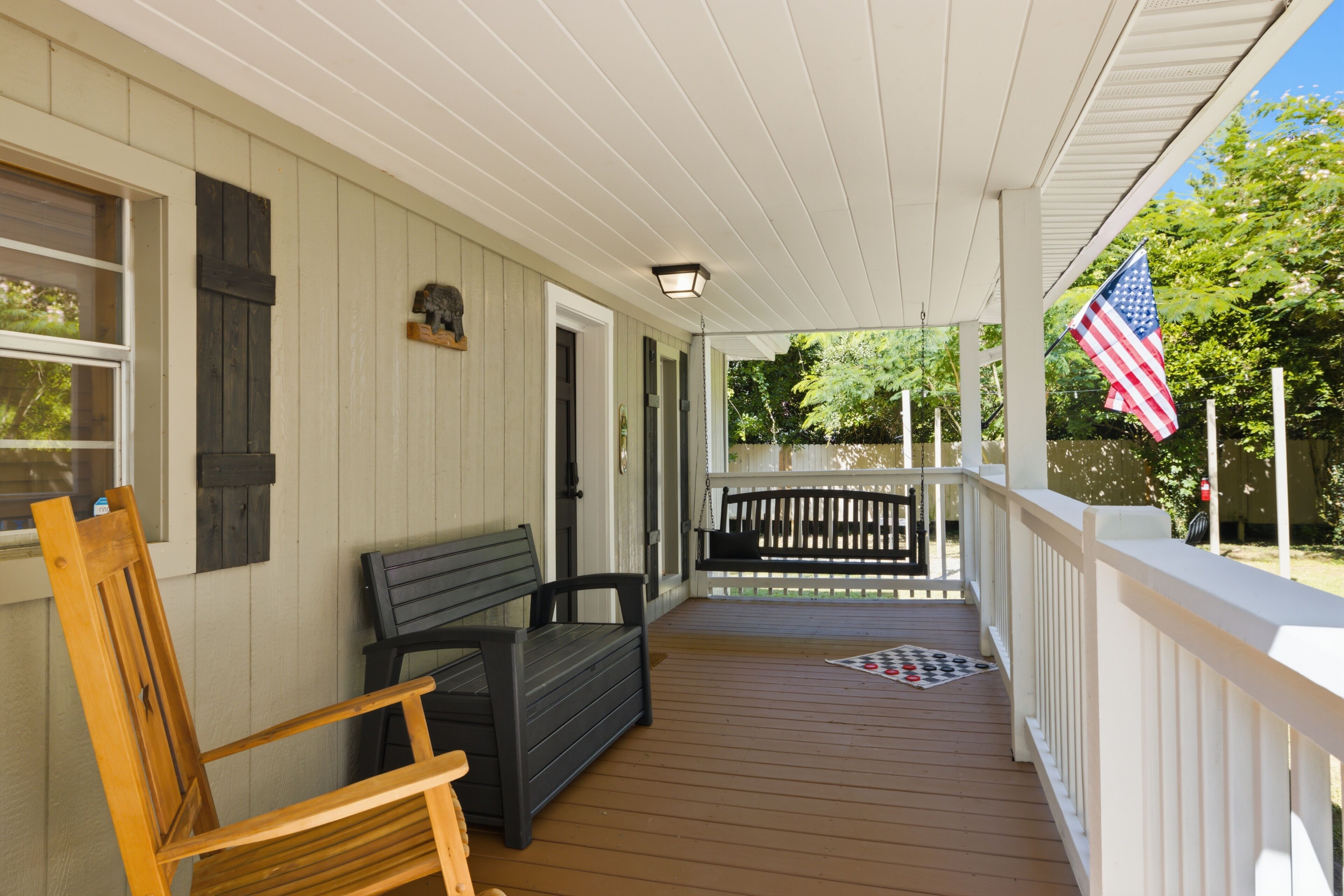 Relax on the covered porch with rocking chair and cozy swing