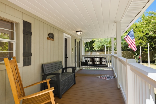 Relax on the covered porch with rocking chair and cozy swing