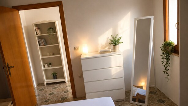 A hotel room with a bed, a dresser, a mirror, and a small shelf with plants. - Aqua Home Area - Core Four (Porto Cesareo)