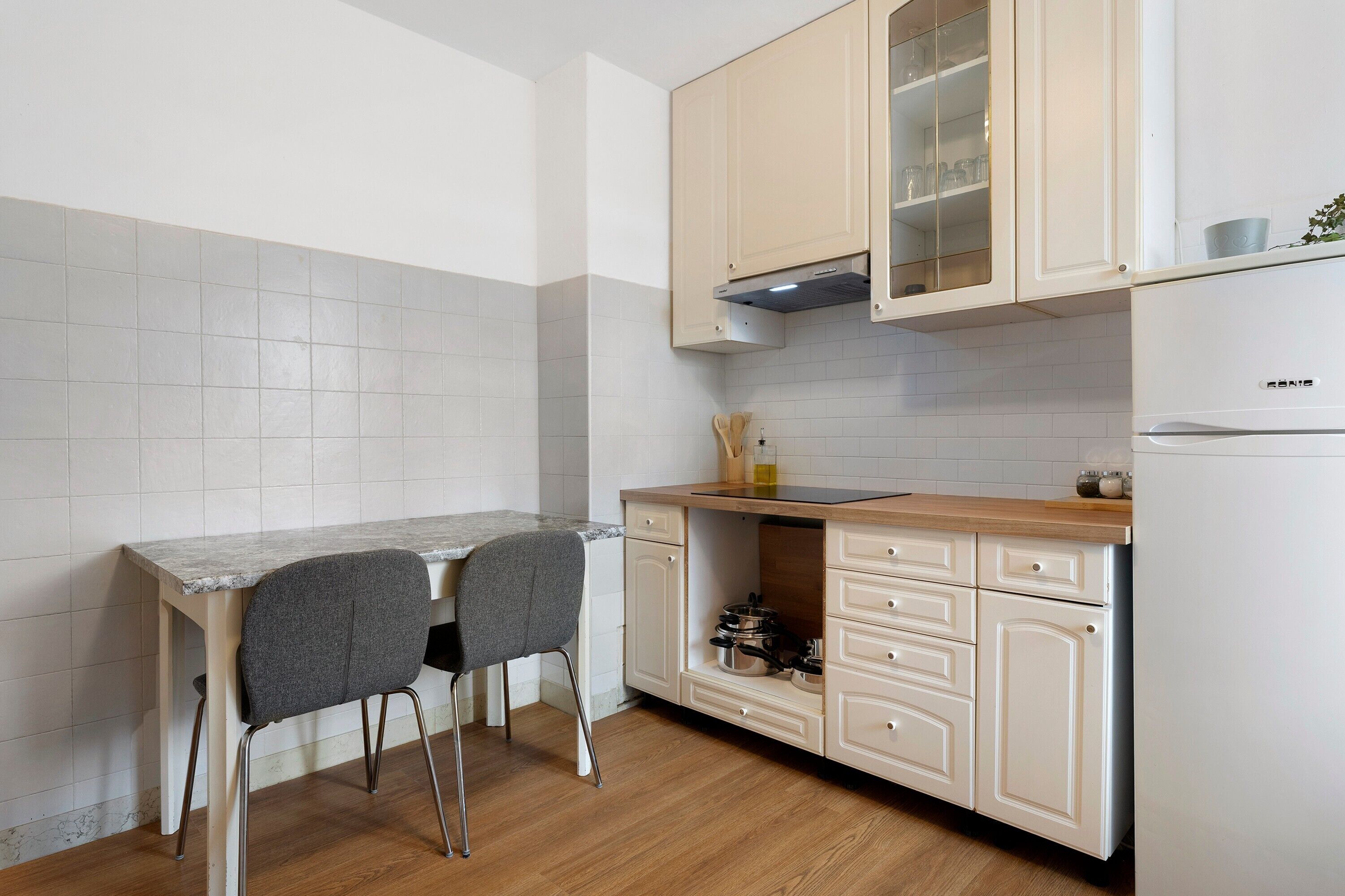 A compact kitchen with a built-in oven, a sink, and a countertop.