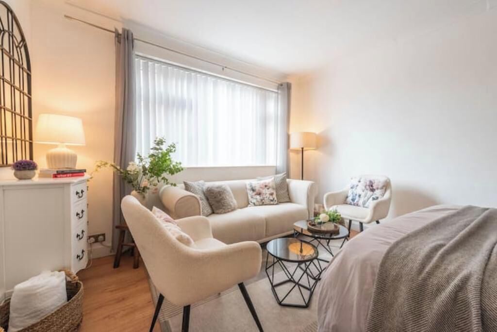 A modern, well-lit room with a sofa, armchair, and a small coffee table.