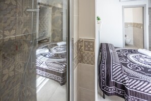 A bathroom with a shower, a sink, and a mirror. - At the Court of the Gods - Demeter Room (Tropea)