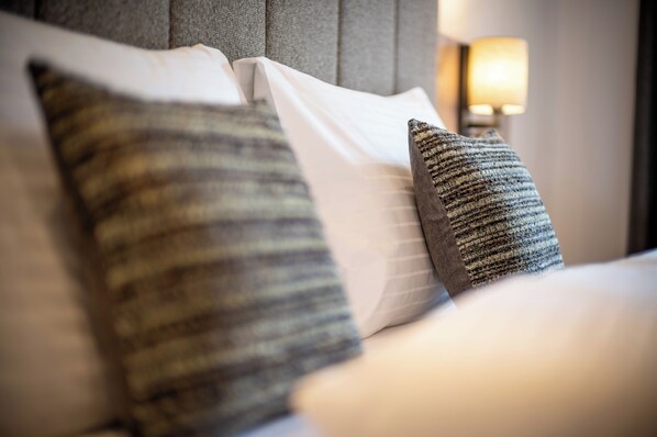 A bed with pillows and a headboard.