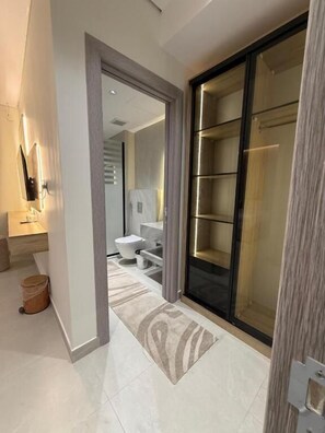 A modern bathroom with a glass shower enclosure, a toilet, and a sink. - OrbitNet - Asasiat 36 (Madina)