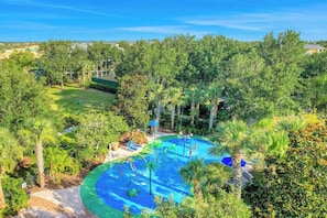 A swimming pool surrounded by lush greenery and trees.