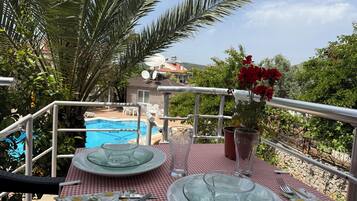 Family Quadruple Room, Balcony, Pool View | Outdoor dining