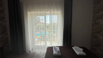 Family Quadruple Room, Balcony, Pool View | Laptop workspace, free WiFi