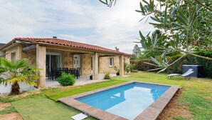 A house with a swimming pool, stone exterior, and a patio with outdoor furniture. - Périgord House: Private Terrace, Wi-Fi & Air Conditioning (Pazayac)