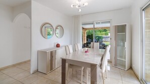 A dining area with a table, chairs, a cabinet, and a chandelier. - Périgord House: Private Terrace, Wi-Fi & Air Conditioning (Pazayac)