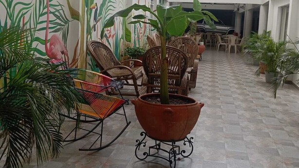 A spacious indoor area with a high ceiling, multiple levels, and a central atrium with seating and potted plants. - Hotel Casa Grande  (Agustín Codazzi)