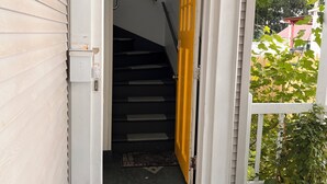 Eine Treppe führt zu einer Tür mit einer Fußmatte.