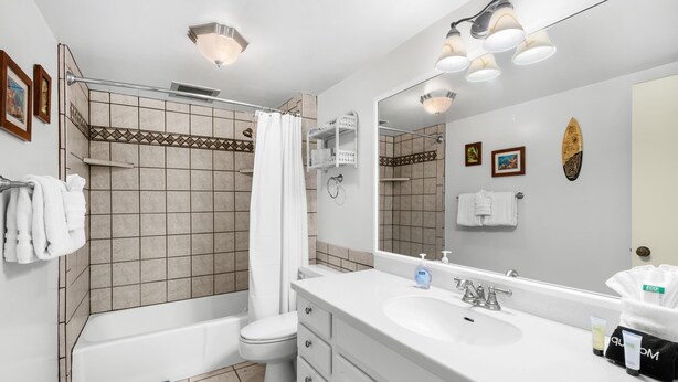 A modern bathroom with a bathtub, toilet, and sink. - Kona Makai 3-102 No Stairs, Ocean View, With AC! (Kailua-Kona)