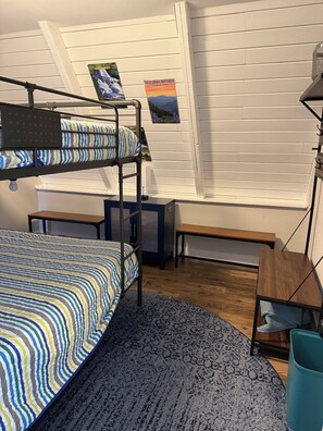 A bunk bed room with a window, a desk, a chair, and a small table. - Cozy 2-bedroom Family Friendly Lakefront Chalet (Oak Ridge)