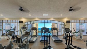 A gym with treadmills, stationary bikes, and ellipticals arranged in rows. - Brand New Sonoran Star Luxury Oceanfront Studio (Puerto Peñasco)