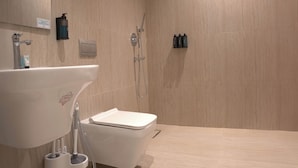 A modern bathroom with a sink, toilet, and shower. - Orbitnet - MB25 (Madinah)