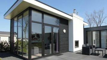 A modern house with large glass windows, a flat roof, and a minimalist design.