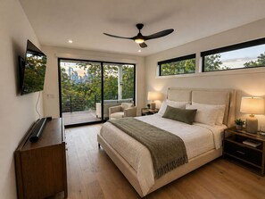 A modern bedroom with a large bed, a ceiling fan, a TV, and a city view. - New Build Downtown Views Pool Spa Walkable (Austin)