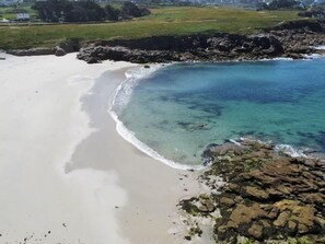 A coastal beach with clear water, sandy shore, and rocky outcrops. - Luxury Duplex With Magnificent sea View (Landeda)