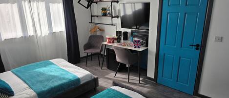 Deluxe Double or Twin Room | Desk, laptop workspace, blackout drapes, iron/ironing board