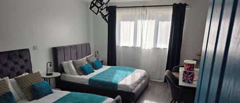 Deluxe Double or Twin Room | Desk, laptop workspace, blackout curtains, iron/ironing board
