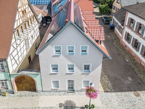 A multi-story building with a symmetrical facade, a central entrance with a large arched doorway, and a tiled roof. - Emma (S5) by Interhome (Endingen am Kaiserstuhl)