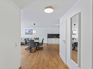 A modern kitchen with white cabinets and a black countertop.