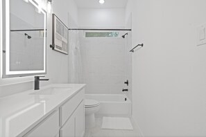 Regadera, secadora de cabello, toallas, papel de baño 