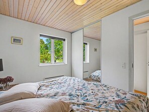 A bedroom with a bed, a window, and a mirror. - "Zelda" - 275m from the sea by Interhome (Millinge)