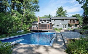 A residential property with a swimming pool, a covered deck, and a two-story house with a balcony. - Private Pool - Hot Tub - Sauna - Game Room - Pets (Sun Prairie)