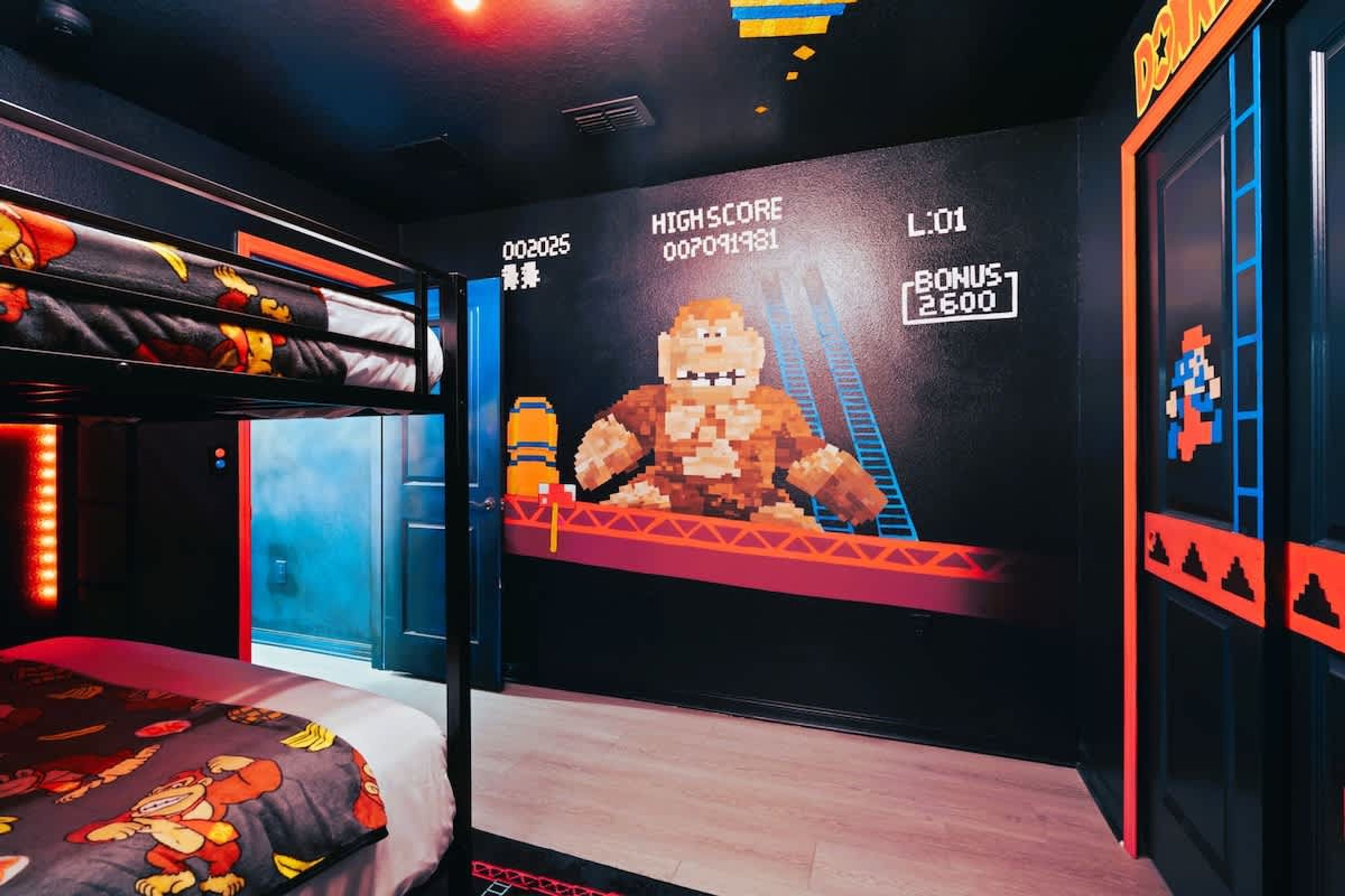A room with a bunk bed, a large pixelated mural, and a digital scoreboard.
