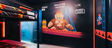 A room with a bunk bed, a large pixelated mural, and a digital scoreboard.