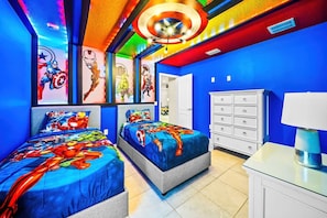 A bedroom with two beds, a dresser, and a nightstand. - Resort Home Private Pool and Spa Outdoor Theater (Kissimmee)