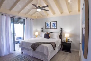 A bedroom with a bed, two bedside tables with lamps, a ceiling fan, and artwork on the wall. - 3 Private Separate Bedrooms, Ironshore Montego Bay (Montego Bay)