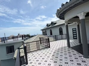 A building with a tiled roof, a balcony with a railing, and a door. - 3 Bedrooms, Ironshore Montego Bay (Montego Bay)