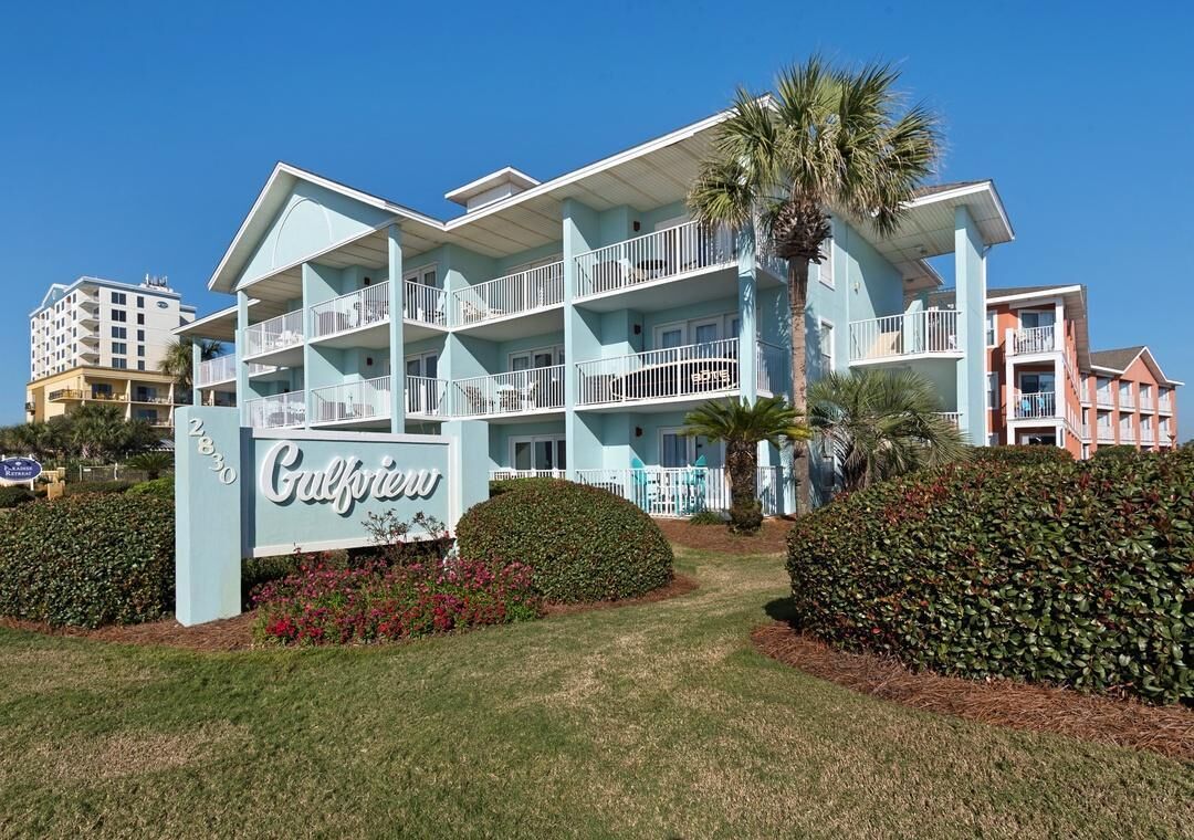 A multi-story hotel with balconies, a sign reading 'Gulfview,' and well-maintained landscaping.