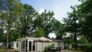 A mobile home with a patio area, including a table and chairs, and a covered seating area. - Holiday Home in Arnhem With Terrace (Arnhem)