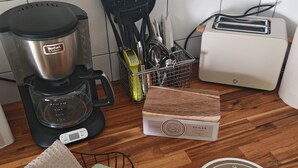 A kitchen with a coffee maker, toaster, and a box of sugar. - A 35-square-meter studio in the heart of downtown, just a stone's throw from all the attractions. (Béziers)