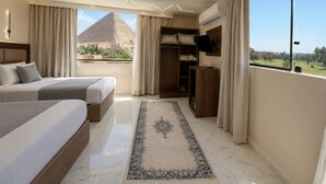 A hotel room with two beds, a wardrobe, a desk, a TV, and a large window with a view of a pyramid. - glow pyramid view (Giza)