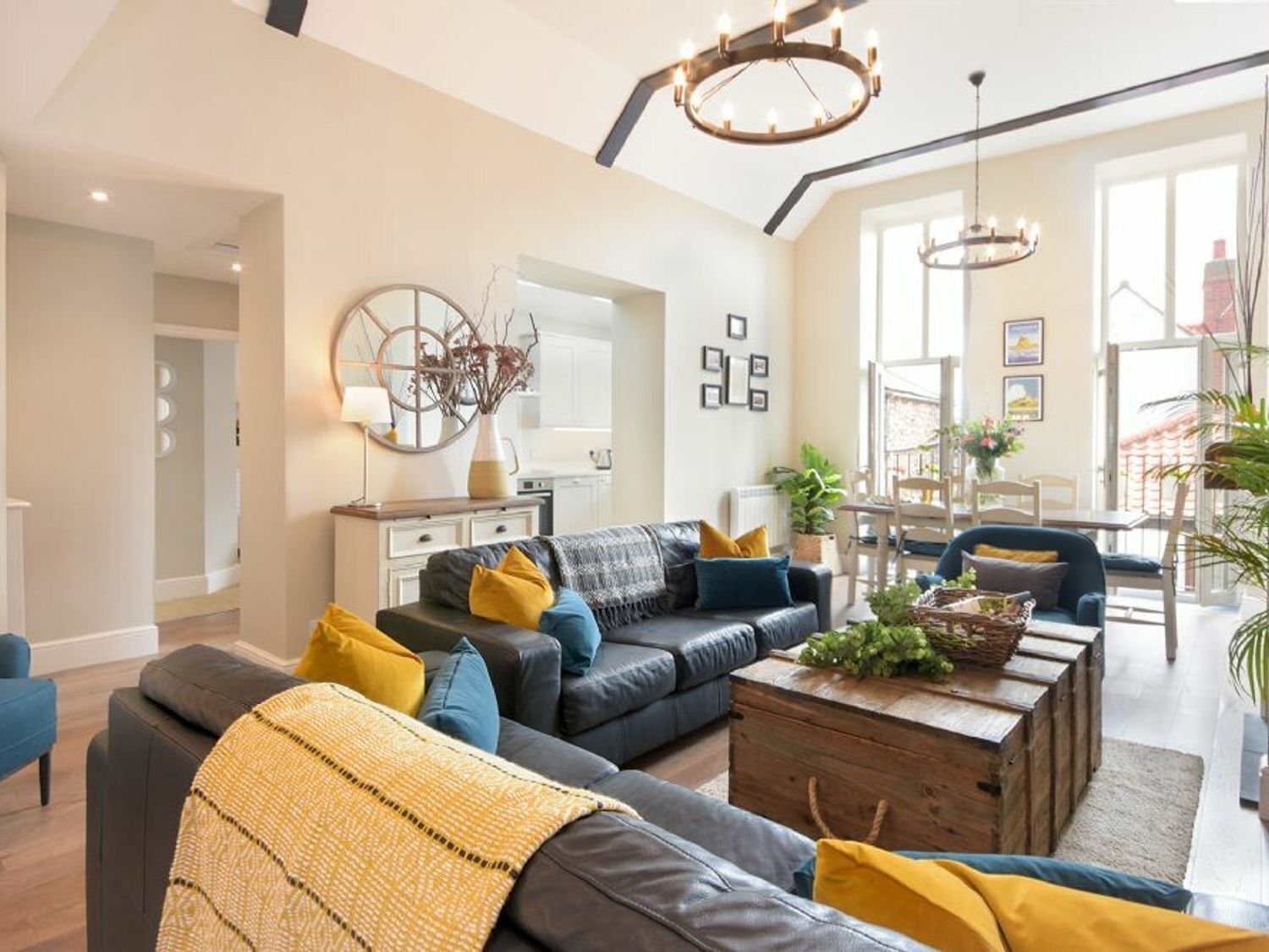 A modern living room with a sofa, coffee table, and decorative items.