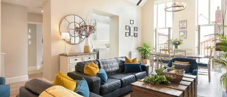 A modern living room with a sofa, coffee table, and decorative items.