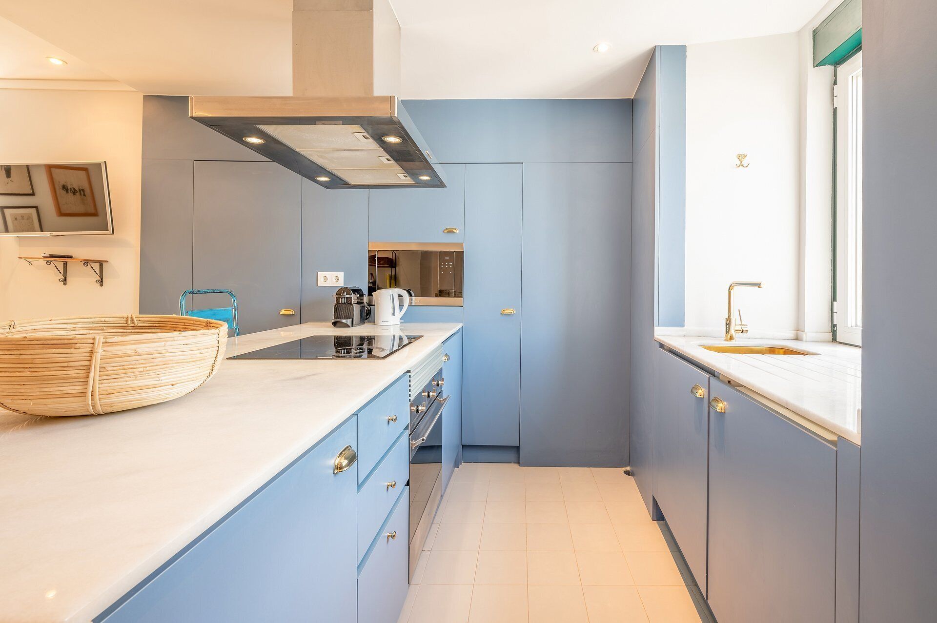 A compact kitchen with a built-in stove, a coffee maker, and a window with a view.