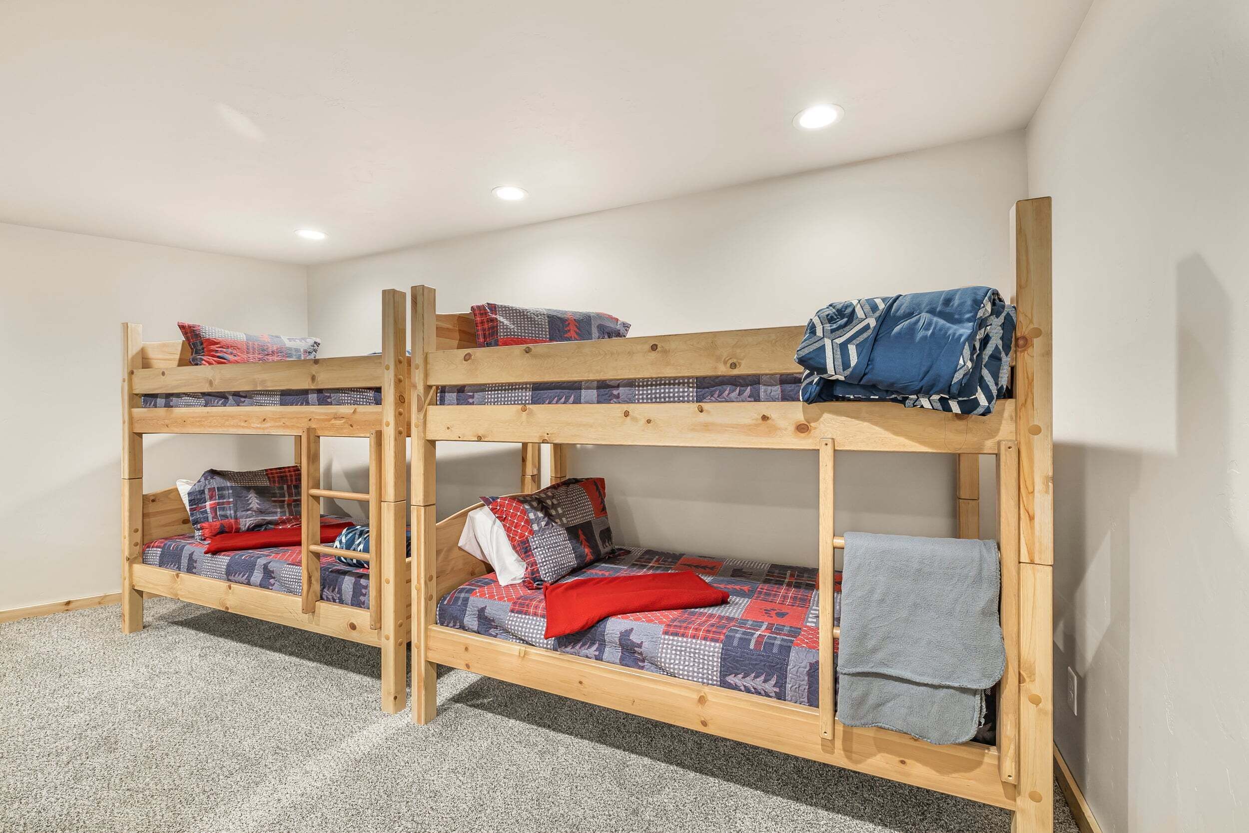 A bunk bed with two levels, each with pillows and blankets.