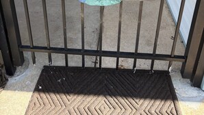 A gated entrance with a sign reading 'CAPTAIN'S QUARTERS' and a nautical-themed decoration.