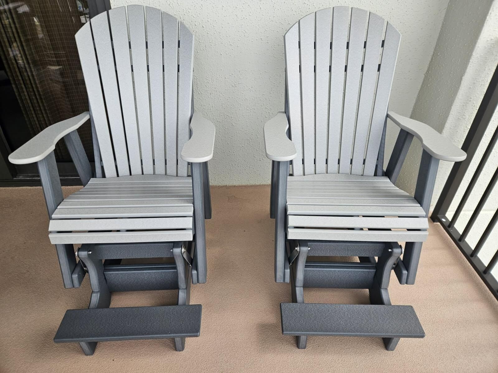 Two Adirondack chairs with armrests and footrests, positioned on a beige carpeted floor.