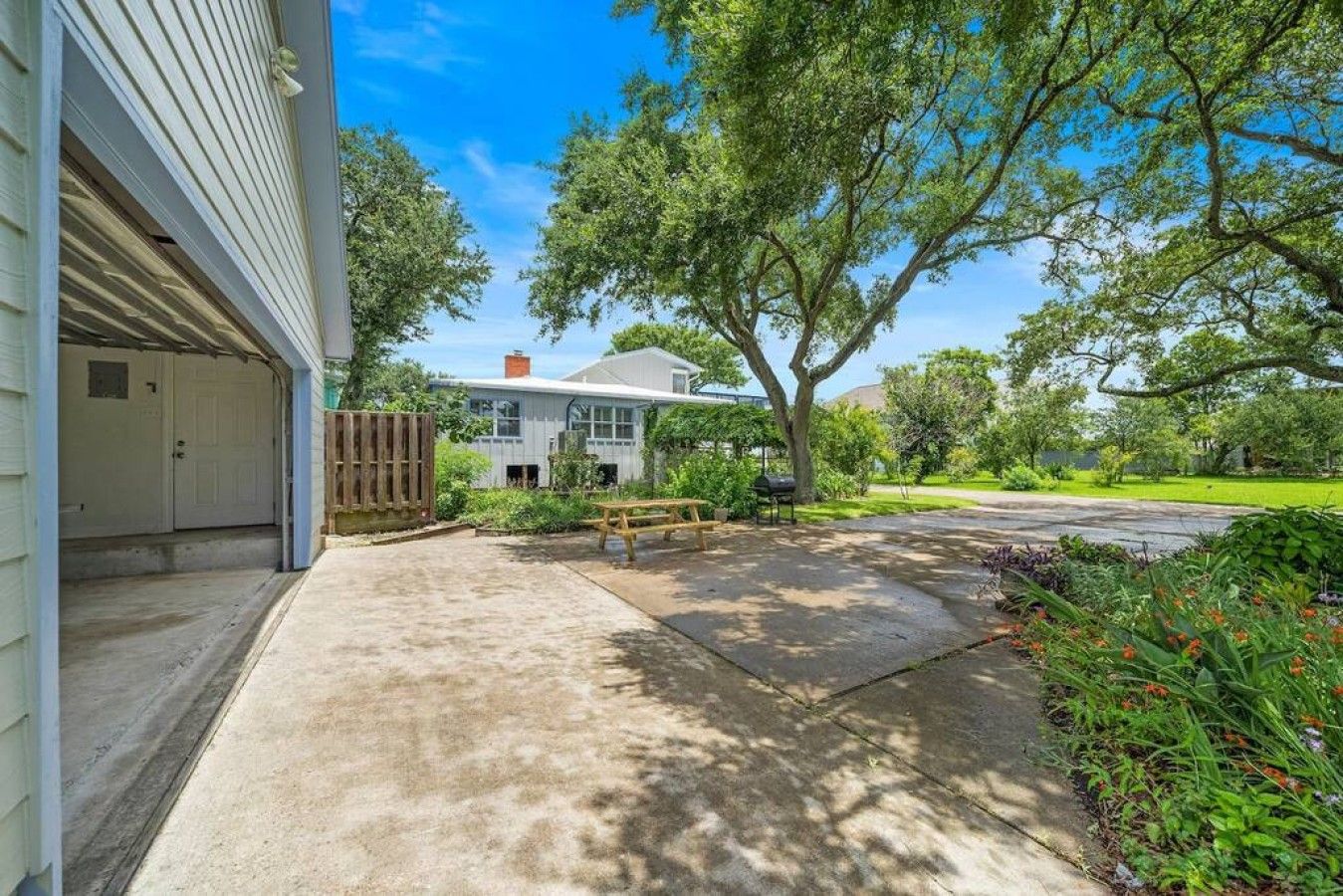 Una propiedad residencial con garaje, un patio techado y césped.