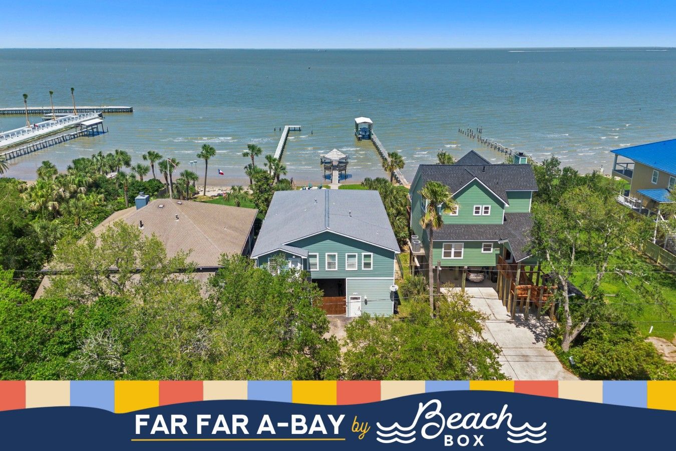 A coastal property with multiple houses, a pier, and a beach view.